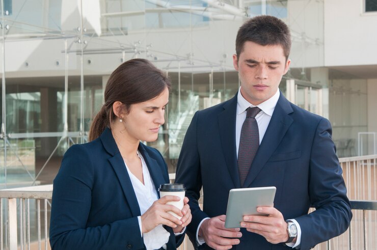 Employers reviewing candidate profiles on a tablet